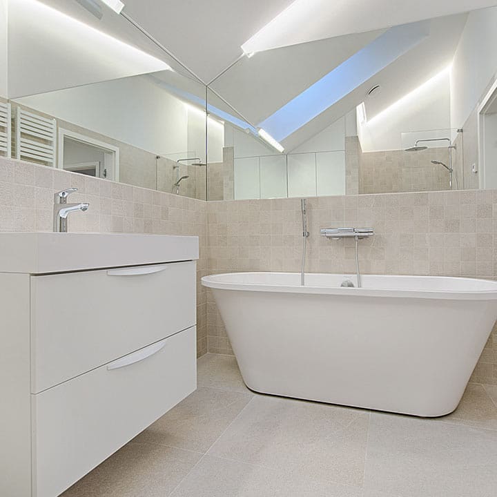 bath tub and sink with with tiled floors and walls