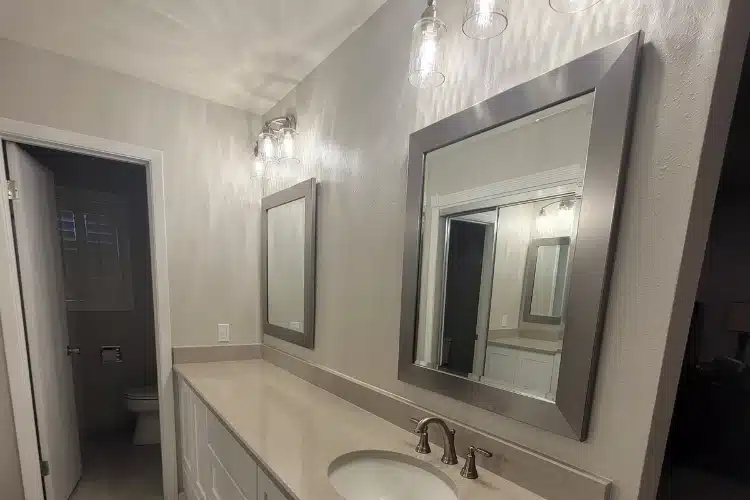 Bathroom with large mirrors and granite countertop