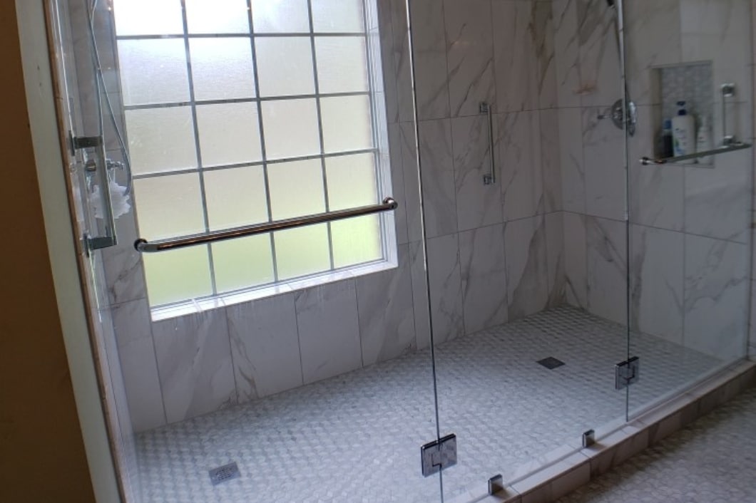 Bathroom Shower With White Tiled Walls and Floor in Edna