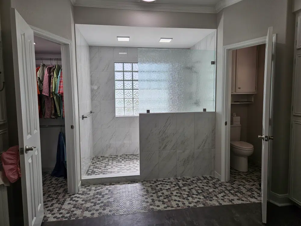 Modern walk-in shower with frosted glass.