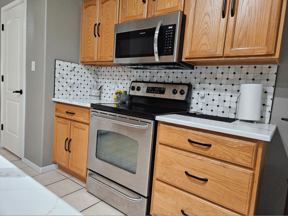 Classic wood cabinets with tiled backsplash.