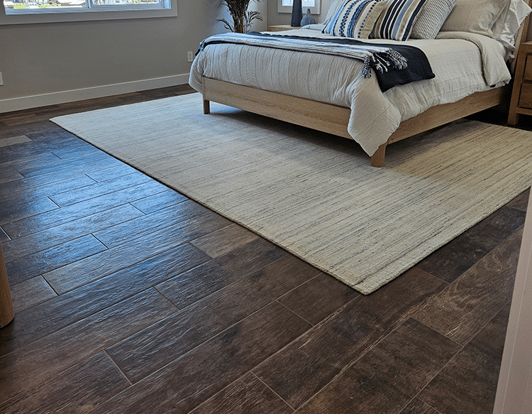 modern bedroom with dark wood-look tile flooring