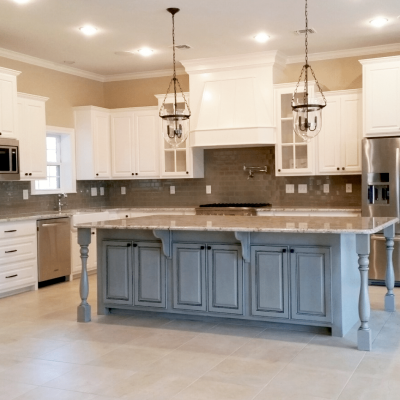 Beautiful open kitchen and island with light colored tile floors
